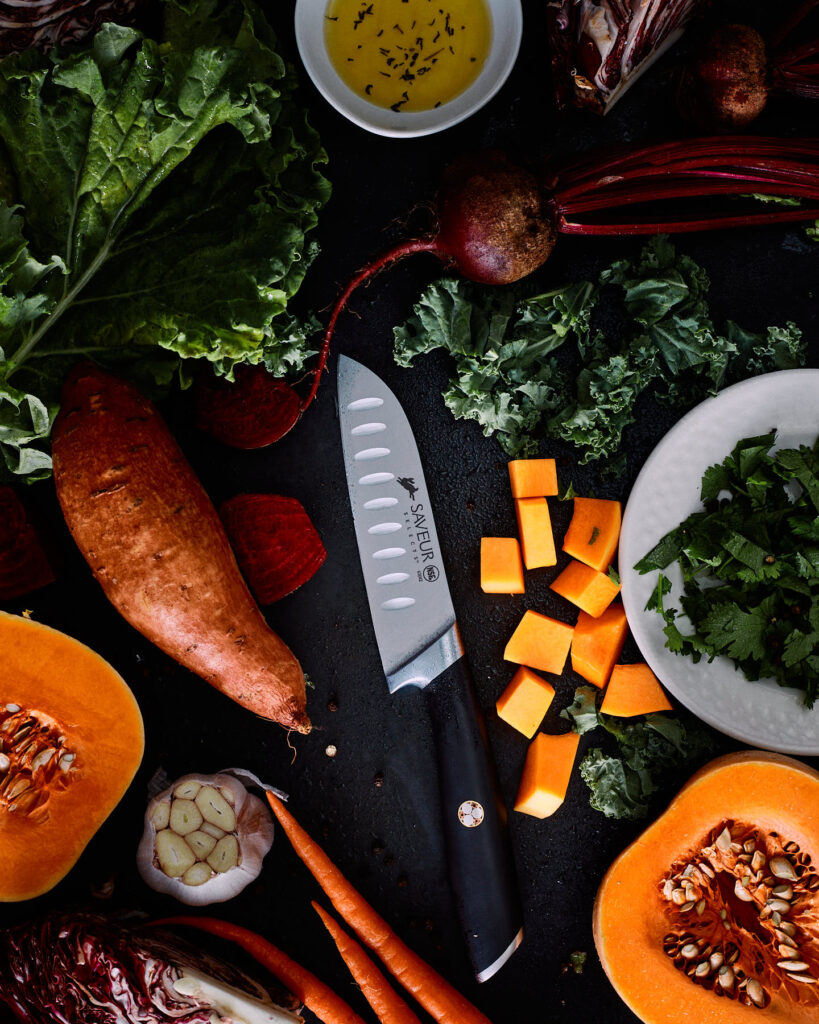 Chopped vegetables circling a Saveur Selects knife