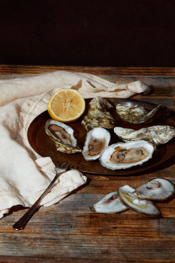 Platter of oysters with half a lemon