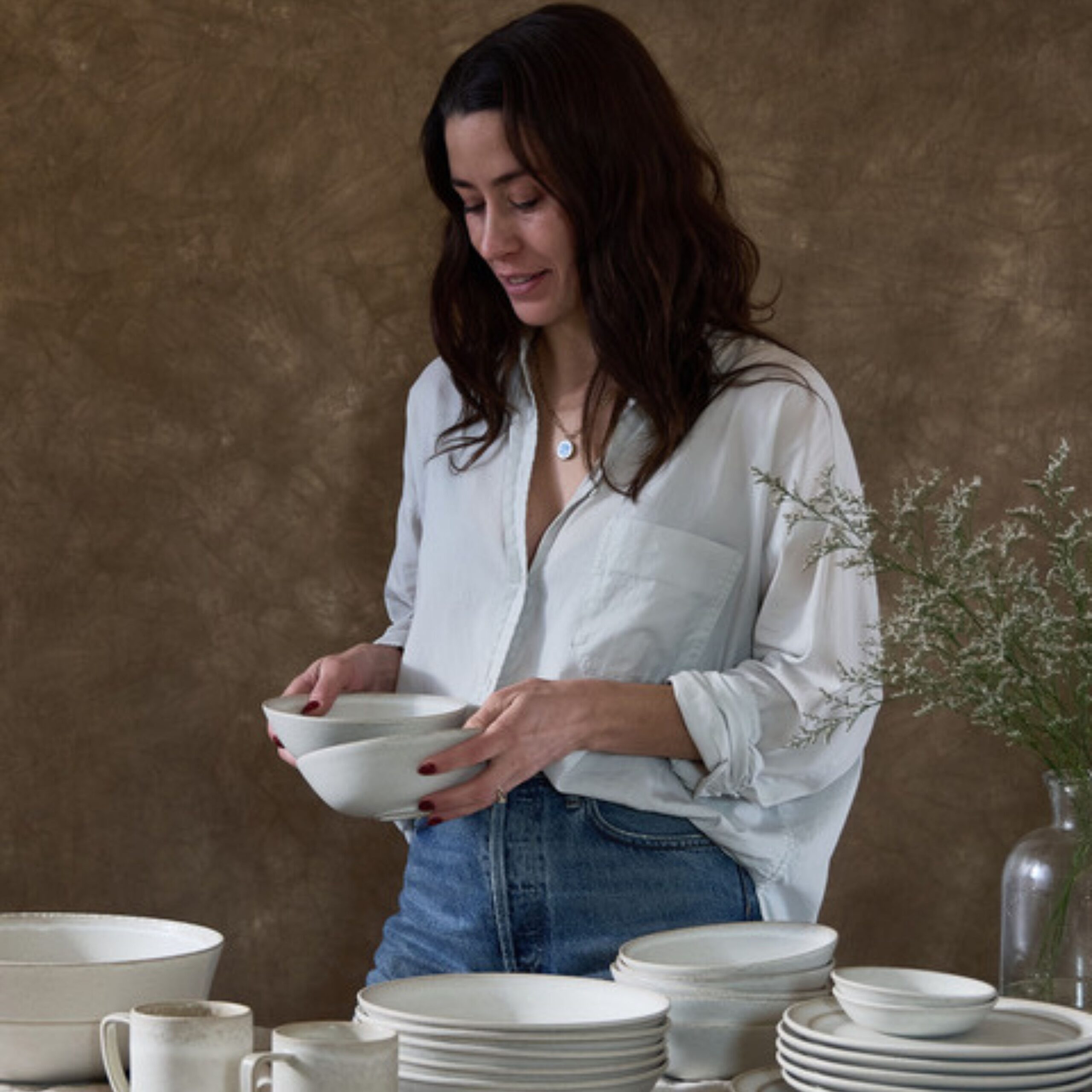 Kira Corbin holding ceramic bowls, featured guest on The Savory Shot Podcast, Episode 064: Building Standard Affair.