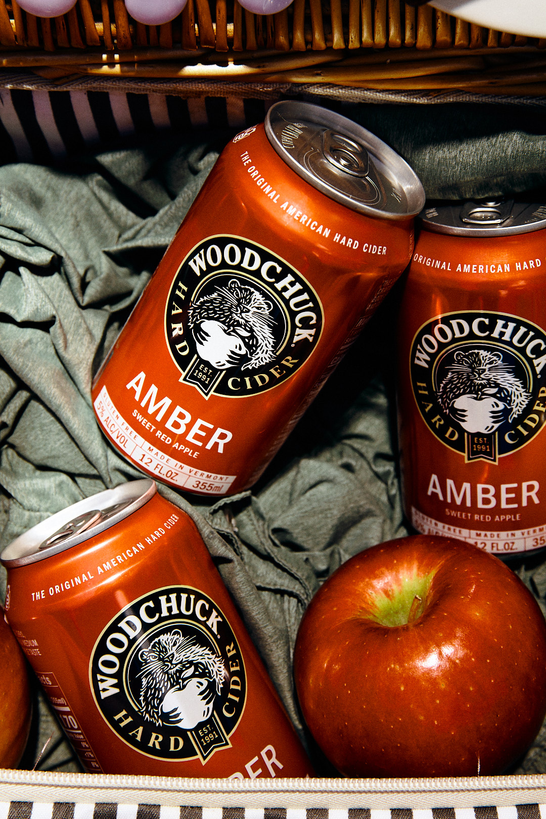 Woodchuck Cider product photography with hard shadows and apple